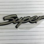 Emblema "super" Tapa Trasera Corsa 98/